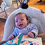 Milann a rejoint le concours — aidez-le/la à gagner de superbes lots ! baby, baby_seat, child, cozy, cute, floor, furniture, happy, home, indoor, infant, laughing, mirror, playtime, plush, room, smiling, soft_book, toy, wearing_clothes