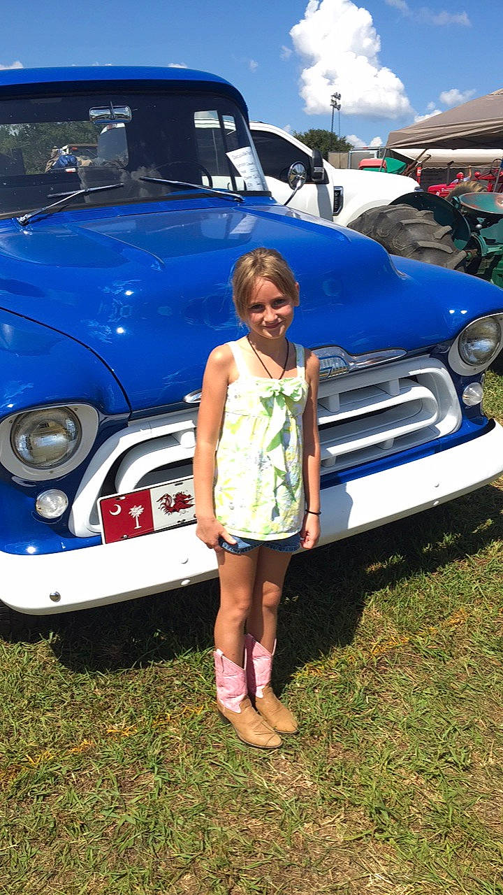 Lizzie is registered to the contest to win money with this photo: automotive_design, automotive_exterior, blue, car, city_car, classic, compact_car, electric_blue, fun, girl, joy, motor_vehicle, person, vacation, vehicle, vintage_car