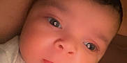 Zyaire is registered to the contest to win money with this photo: baby, infant, face, eyes, clothing, mitten, closeup, portrait, skin, child, person, young, cute, expression, head, resting, warm_light, indoors, newborn, soft