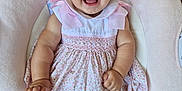 Diana joined the competition — help win amazing prizes! baby, child, smiling, pink_bow, blue_eyes, floral_dress, pink_socks, flower_accessory, cushioned_seat, indoor, happy, portrait, cute, infant, person, baby_seat, small_child, dressed_up, soft_fabric, comfortable
