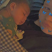 Braxton is registered to the contest to win money with this photo: baby, sleeping, adult, face_filter, butterfly_filter, blanket, checkered_blanket, closeup, indoor, cozy, rest, tender, family, child, person, soft_light, portrait, nap, comfort, skin