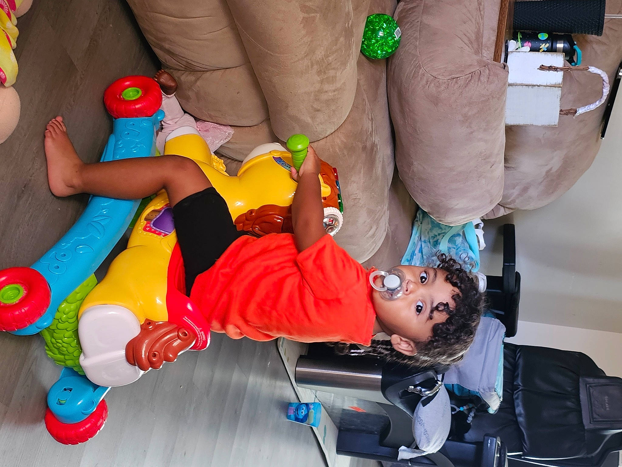 Braelyn is registered to the contest to win money with this photo: baby, baby_products, baby_toys, child, comfort, fictional_character, foot, fun, green, human_leg, knee, leisure, person, play, recreation, room, sock, thigh, toddler, toe
