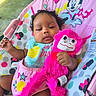 baby, infant, toy, plush_toy, pink, mickey_mouse, minnie_mouse, baby_seat, colorful, outdoor, child, cute, relaxed, clothing, bib, patterned, smile, hand, face, curly_hair