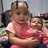 toddler, baby, child, indoor, holding, pink_clothing, beads, braids, blanket, family, caring, portrait, infant, cute, person, home, love, seated, expression, comfort