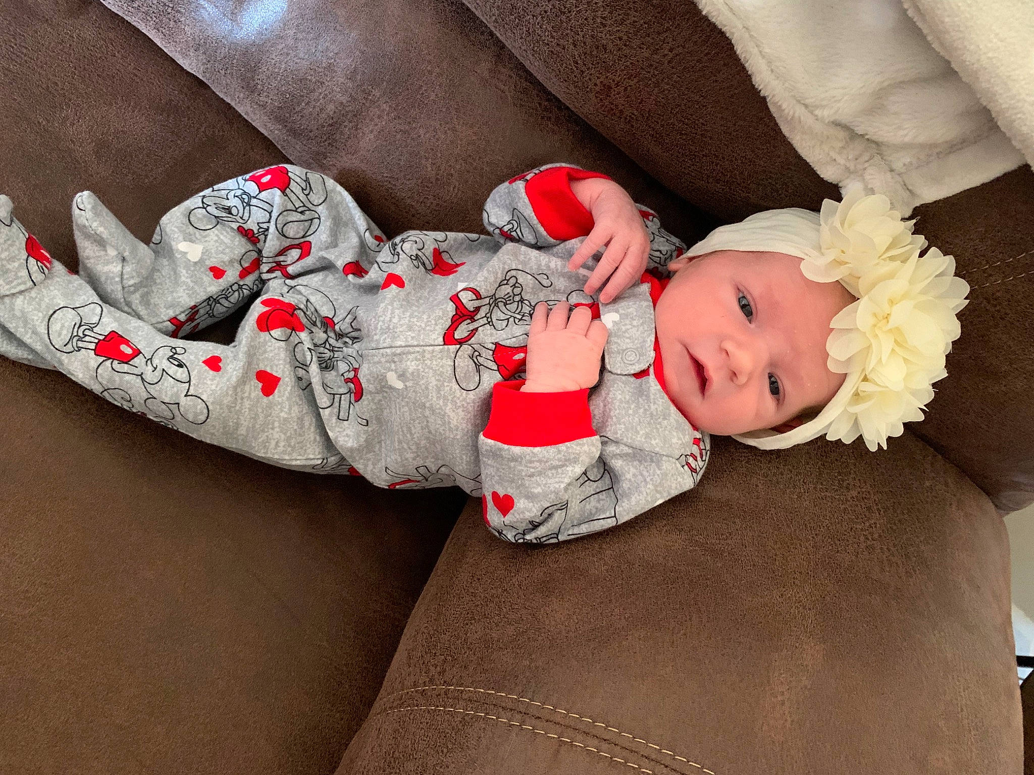 Karsyn is registered to the contest to win money with this photo: baby, baby_products, baby_sleeping, baby_toddler_clothing, carmine, child, comfort, face, hat, headwear, human_body, lap, pattern, person, plant, sitting, skin, sleeve, sock, textile