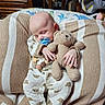 baby, baby_car_seat, bald_head, beige_color, blanket, cozy, crib_pillow, dresser, hand, head, infant, knitted_toy, onesie, pacifier, patterned_bedding, portrait, sleeping, soft_toy, stuffed_bear, wooden_furniture