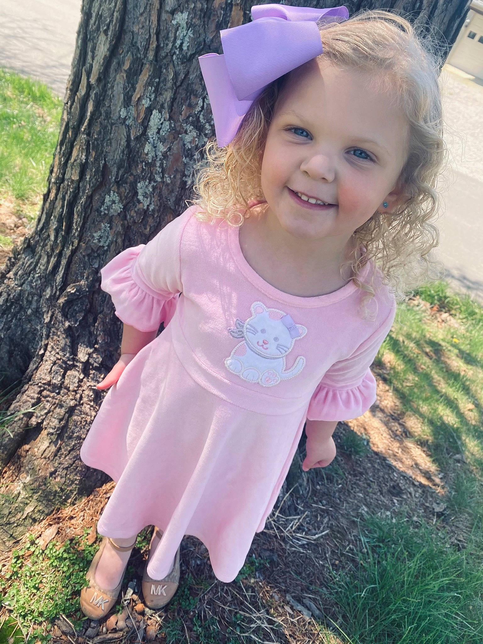 Marsley is registered to the contest to win money with this photo: baby_toddler_clothing, beauty, dress, facial_expression, gesture, grass, happy, iris, joy, light, magenta, people_in_nature, person, pink, plant, purple, skin, sleeve, smile, summer