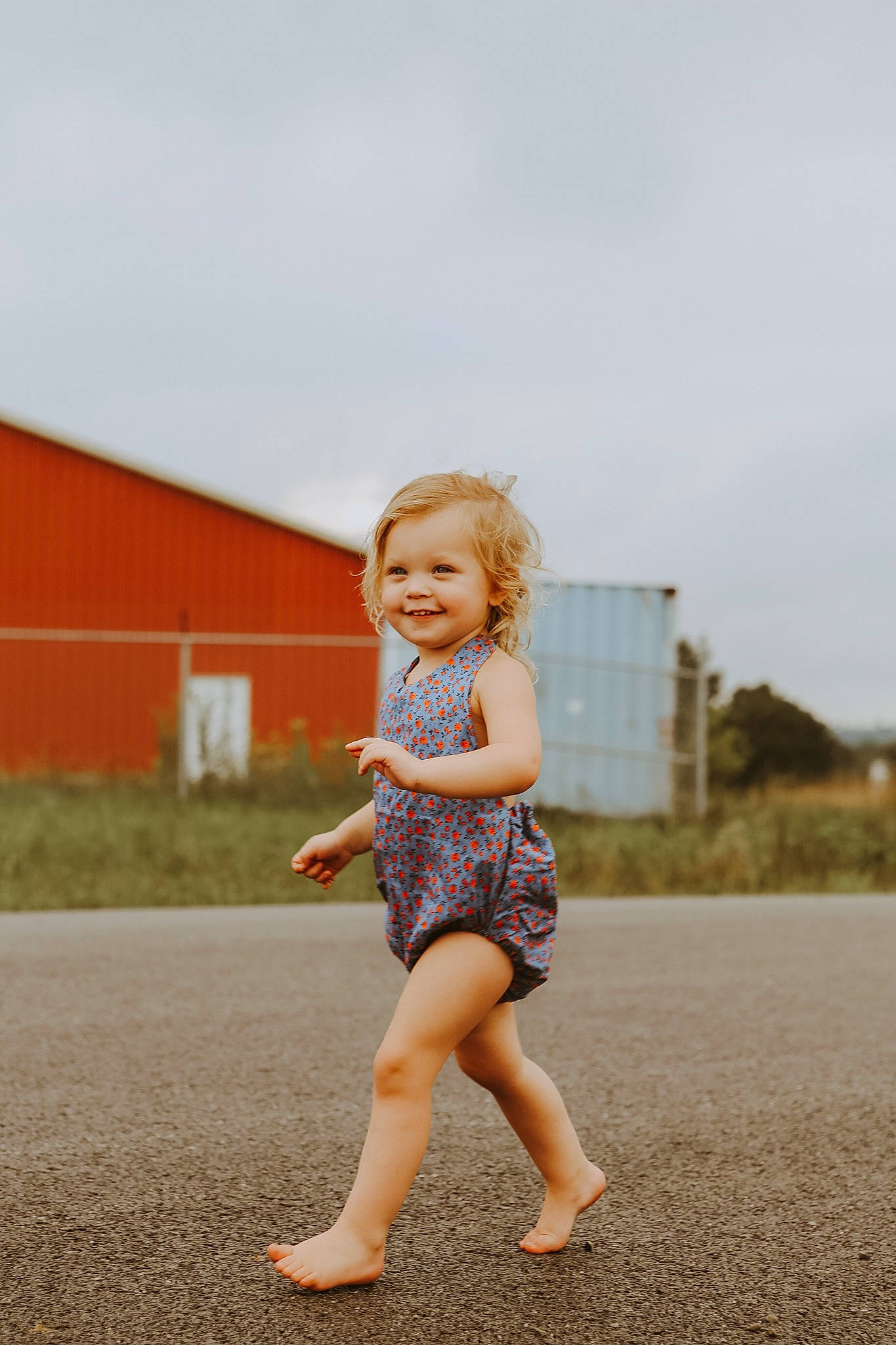 Chevelle is registered to the contest to win money with this photo: asphalt, barefoot, blond, denim, dress, flash_photography, fun, grass, happy, human_leg, joy, landscape, leg, people_in_nature, person, plant, sky, smile, standing, t_shirt