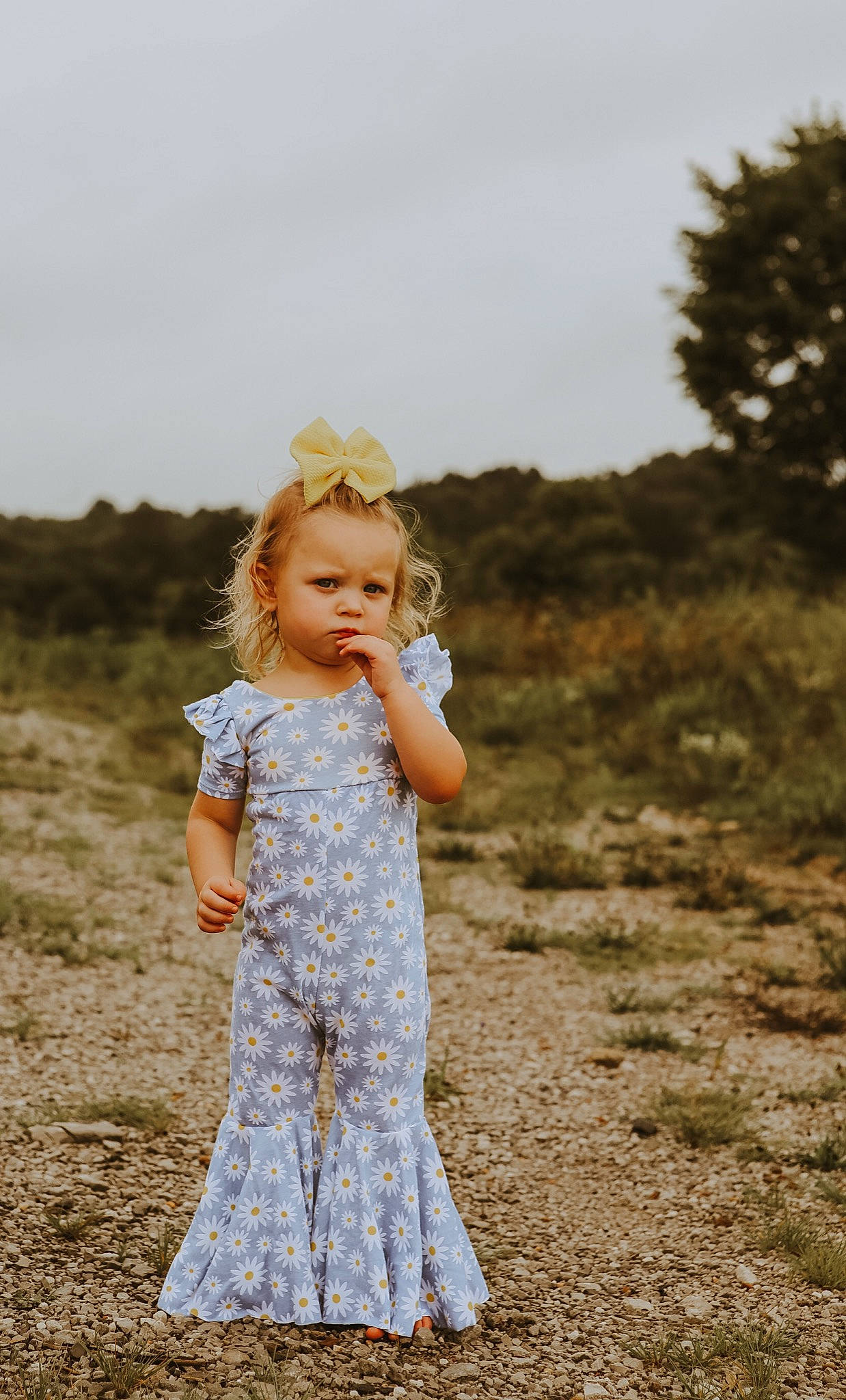 Chevelle is registered to the contest to win money with this photo: brown_hair, child, day_dress, dress, facial_expression, field, flash_photography, fun, grass, grassland, happy, landscape, meadow, people_in_nature, person, plant, prairie, sky, sleeve, toddler