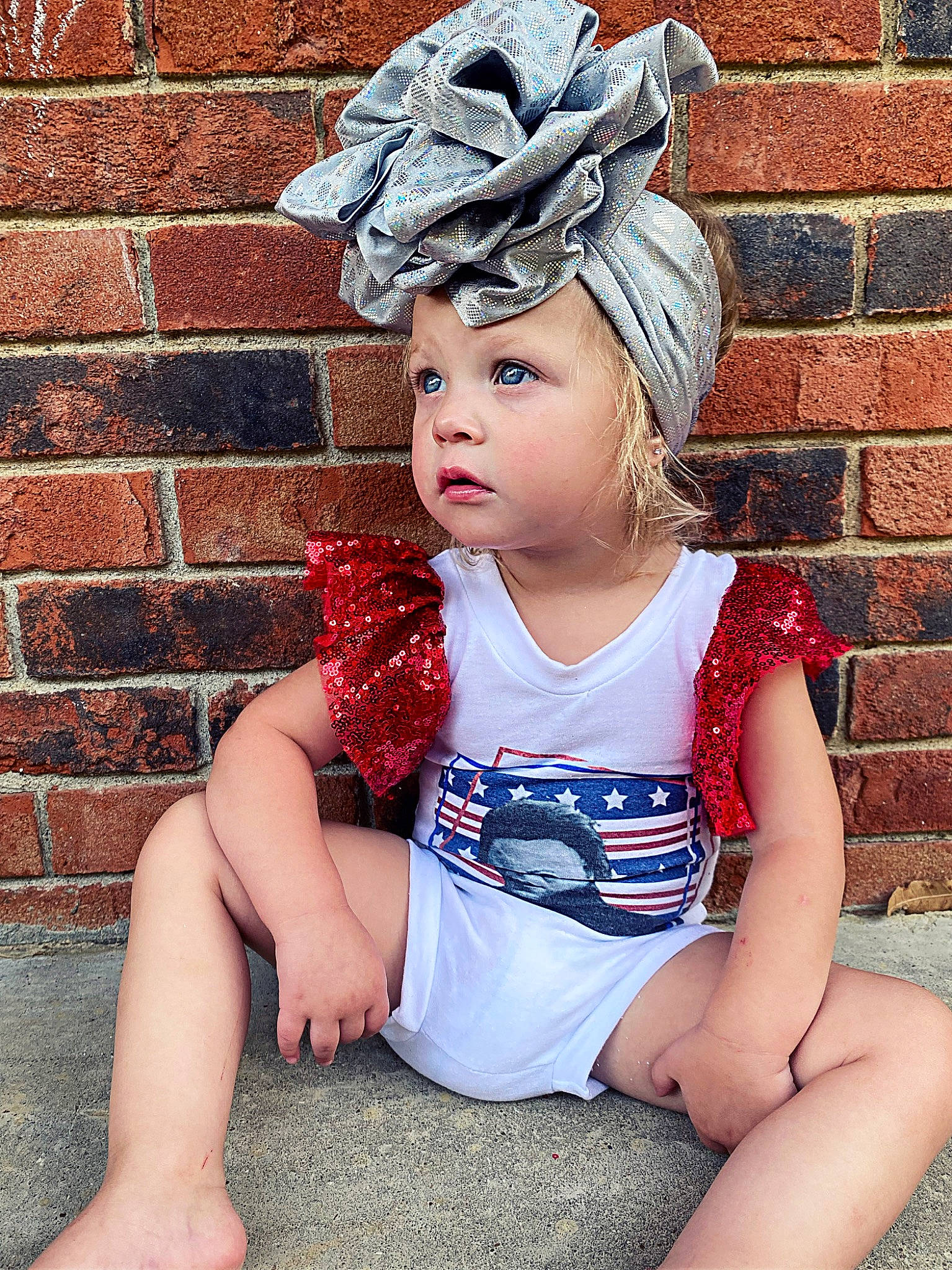 Chevelle is registered to the contest to win money with this photo: baby_toddler_clothing, brick, brickwork, cap, child, costume_hat, electric_blue, eye, flash_photography, fun, grass, happy, headgear, headpiece, headwear, human, human_leg, pattern, person, pink