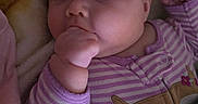 Lily joined the competition — help win amazing prizes! baby, blanket, child, cozy, cute, expression, face, fist, hand, indoors, infant, newborn, onesie, portrait, purple, resting, sleepwear, soft_lighting, striped_clothing, young