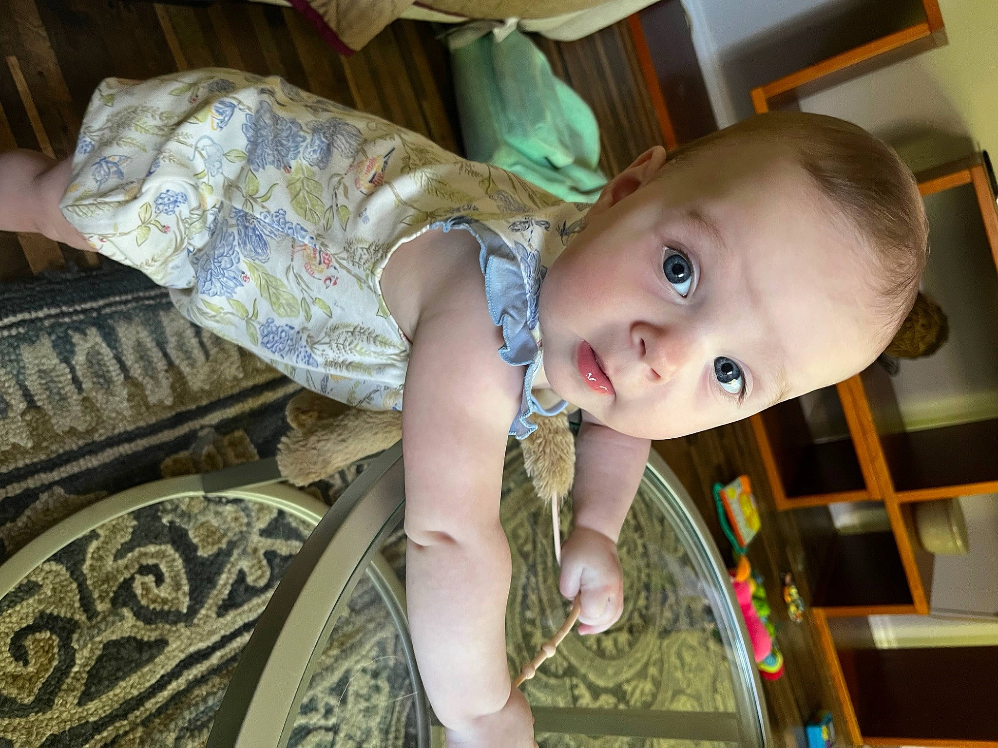 Lucy is registered to the contest to win money with this photo: automotive_tire, baby, baby_products, baby_safety, baby_toddler_clothing, cheek, child, facial_expression, flooring, fun, happy, iris, mouth, pattern, person, room, sitting, skin, smile, toddler