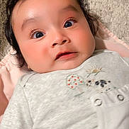 Vik is registered to the contest to win money with this photo: baby, carpet, child, clothing, curly_hair, cute, embroidery, expression, eyes, face, indoors, infant, long_eyelashes, lying_down, person, pink_blanket, portrait, skin, soft_texture, young