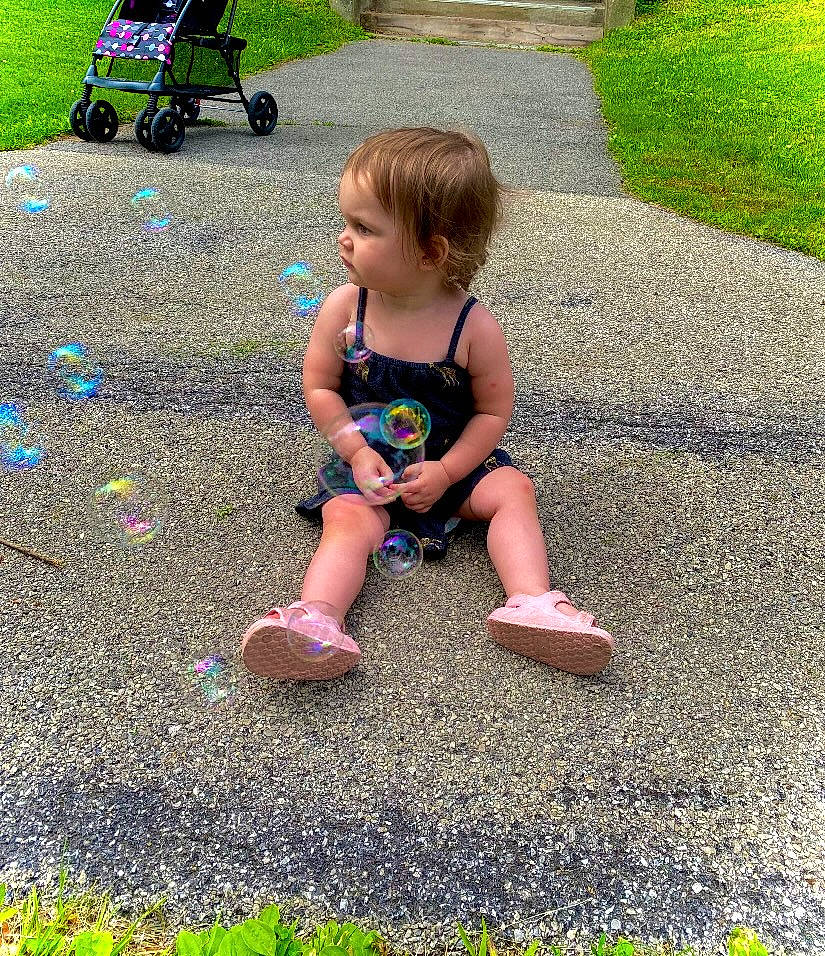 Nicole joined the competition — help win amazing prizes! asphalt, child, foot, fun, grass, human_leg, lawn, leaf, leg, leisure, people_in_nature, person, play, public_space, recreation, road_surface, shoe, shorts, sidewalk, sitting