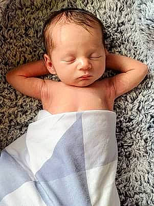 Jaxon is registered to the contest to win money with this photo: abdomen, baby, baby_sleeping, baby_toddler_clothing, cheek, chest, child, comfort, eyelash, face, gesture, hair, happy, linens, neck, pattern, person, skin, sleeve, thumb