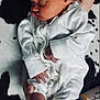 baby, newborn, sleeping, onesie, headband, orange_bow, infant, tattoo, arm, hand, foot, toes, blanket, black_and_white, pattern, closeup, cute, peaceful, person, portrait