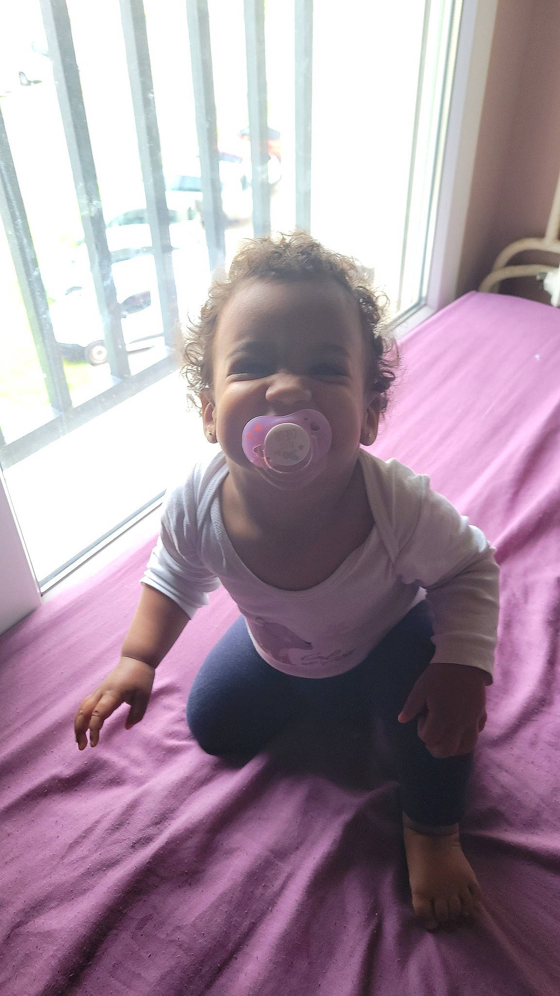 Shendyïa participe au concours pour gagner de l'argent avec cette photo : baby, baby_toddler_clothing, comfort, finger, floor, flooring, fun, happy, magenta, mouth, person, pink, purple, shoulder, skin, sleeve, smile, t_shirt, toddler, window