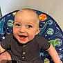 Mason joined the competition — help win amazing prizes! baby, smiling, child, dinosaur, chair, blue, clothing, happy, infant, sitting, cute, portrait, indoor, person, button, shorts, light, face, skin, young