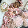 India is registered to the contest to win money with this photo: baby, bed, blanket, bonnet, clothing, couch, crib, cushion, face, furniture, hat, head, homedecor, newborn, person, photography, portrait, quilt, sleeping, toy