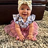 Emmy joined the competition — help win amazing prizes! baby, child, smiling, headband, bow, blue_shirt, pink_tutu, carpet, indoor, couch, happy, cute, young_child, person, sitting, portrait, furniture, playful, clothing, infant