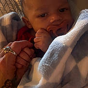 Legend joined the competition — help win amazing prizes! baby, blanket, child, clothing, comfort, cute, face, family, hand, holding, indoor, infant, newborn, pacifier, person, portrait, ring, skin, tattoo, warm