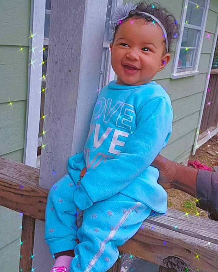 Dorothy is registered to the contest to win money with this photo: baby, baby_products, baby_toddler_clothing, child, electric_blue, fun, happy, headwear, joy, leisure, magenta, outdoor_play_equipment, person, personal_protective_equipment, pink, recreation, sitting, sleeve, smile, swing