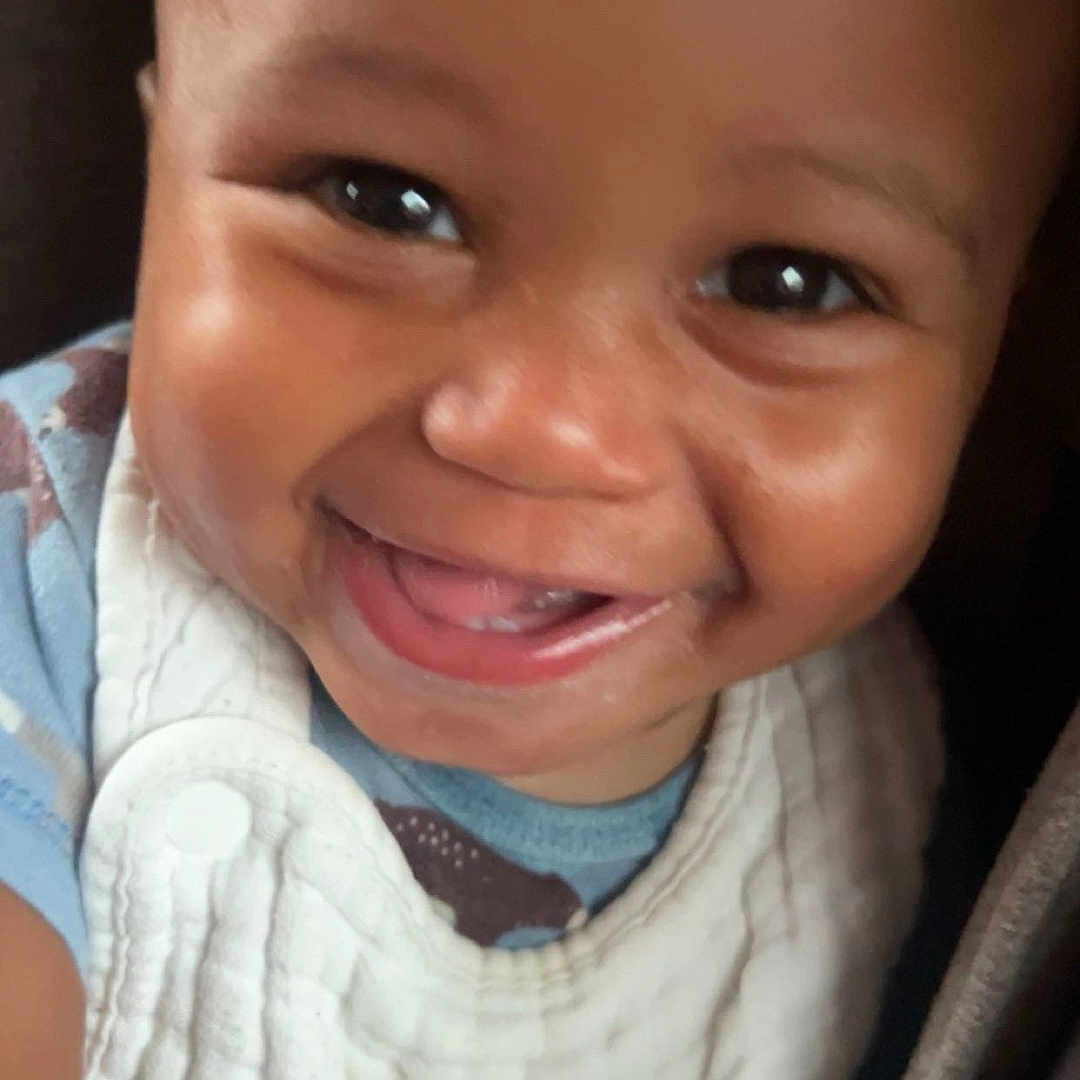 Seryan is registered to the contest to win money with this photo: baby, smiling, face, closeup, bib, bottle, infant, child, happy, cute, skin, clothing, person, portrait, young, joyful, expression, hand, indoors, bright