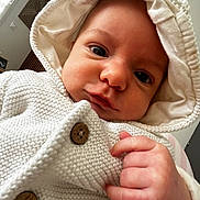 élio a rejoint le concours — aidez-le/la à gagner de superbes lots ! baby, infant, hoodie, knitted_clothing, white, cute, face, hand, indoor, portrait, cozy, child, newborn, button, warm, window, light, skin, candid, expression