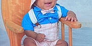 Joseph joined the competition — help win amazing prizes! baby, child, smiling, blue_shirt, plaid, hat, socks, rocking_chair, wooden_chair, happy, baby_clothes, infant, cute, portrait, seated, indoors, person, small_chair, funny_hat, toddler