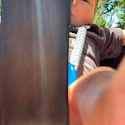 Joshua joined the competition — help win amazing prizes! baby, child, closeup, clothing, curious, daylight, exploration, face, greenery, hand, nature, outdoor, partial_face, peek, person, playful, portrait, sunlight, trees, young_child