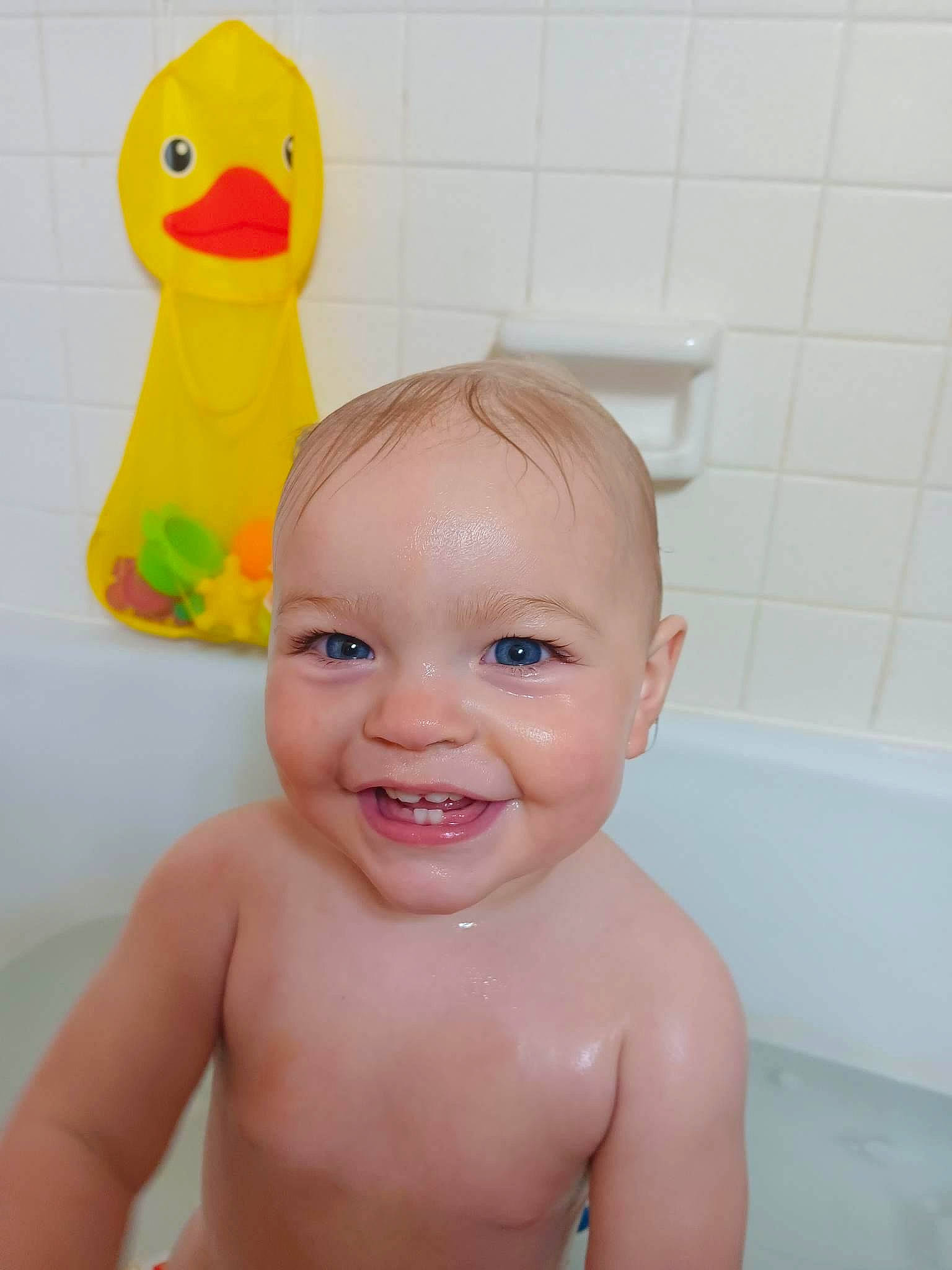 Audrie is registered to the contest to win money with this photo: baby, baby_bathing, bath_toy, bathing, bathroom, bathtub, beak, chest, eye, fluid, fun, happy, head, joy, person, plumbing, skin, smile, toddler, toy