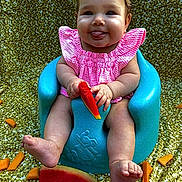 Tilly is registered to the contest to win money with this photo: baby, child, pink_clothing, blue_baby_seat, watermelon, melon_slices, golden_backdrop, smiling, tongue_out, cute, summer, fruit, playful, sitting, happy, chubby_cheeks, outdoor, closeup, infant, food