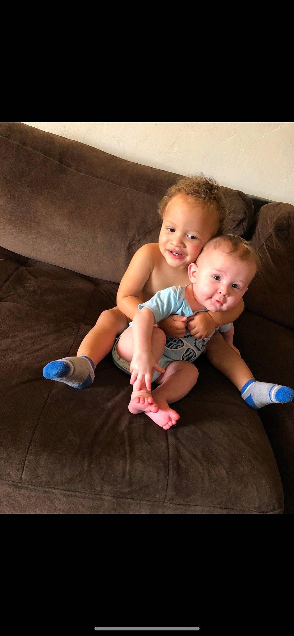 Jackie is registered to the contest to win money with this photo: arm, baby, cheek, child, finger, fun, hand, leg, person, photography, sibling, sitting, skin, smile, thigh, thumb, toddler