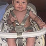 baby, bare_chest, child, curly_hair, cushion, cute, face, foot, furniture, hand, happy, high_chair, indoor, infant, pattern, person, safety_strap, seat, skin, smiling