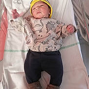 Dhash participe au concours pour gagner de l'argent avec cette photo : baby, newborn, infant, hospital, bassinet, clothing, hat, dinosaur_print, socks, blanket, lying_down, cute, child, person, indoors, portrait, sleepwear, soft, warm, resting