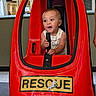 baby, child, toy_car, red, rescue, indoor, play, expression, joy, handle, seat, vehicle, amusement, fun, person, cute, small, happy, entertainment, mall