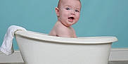 Luca joined the competition — help win amazing prizes! baby, bath_time, bathtub, blue_wall, child, clawfoot_tub, clean, cute, face, floor, happy, head, indoor, plumbing_fixture, portrait, sitting, skin, smiling, towel, waterless