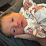 Michael is registered to the contest to win money with this photo: newborn, baby, infant, hand, onesie, clothing, blanket, bed, person, face, skin, sleepwear, cozy, indoors, rest, young_child, cute, small, comfort, soft