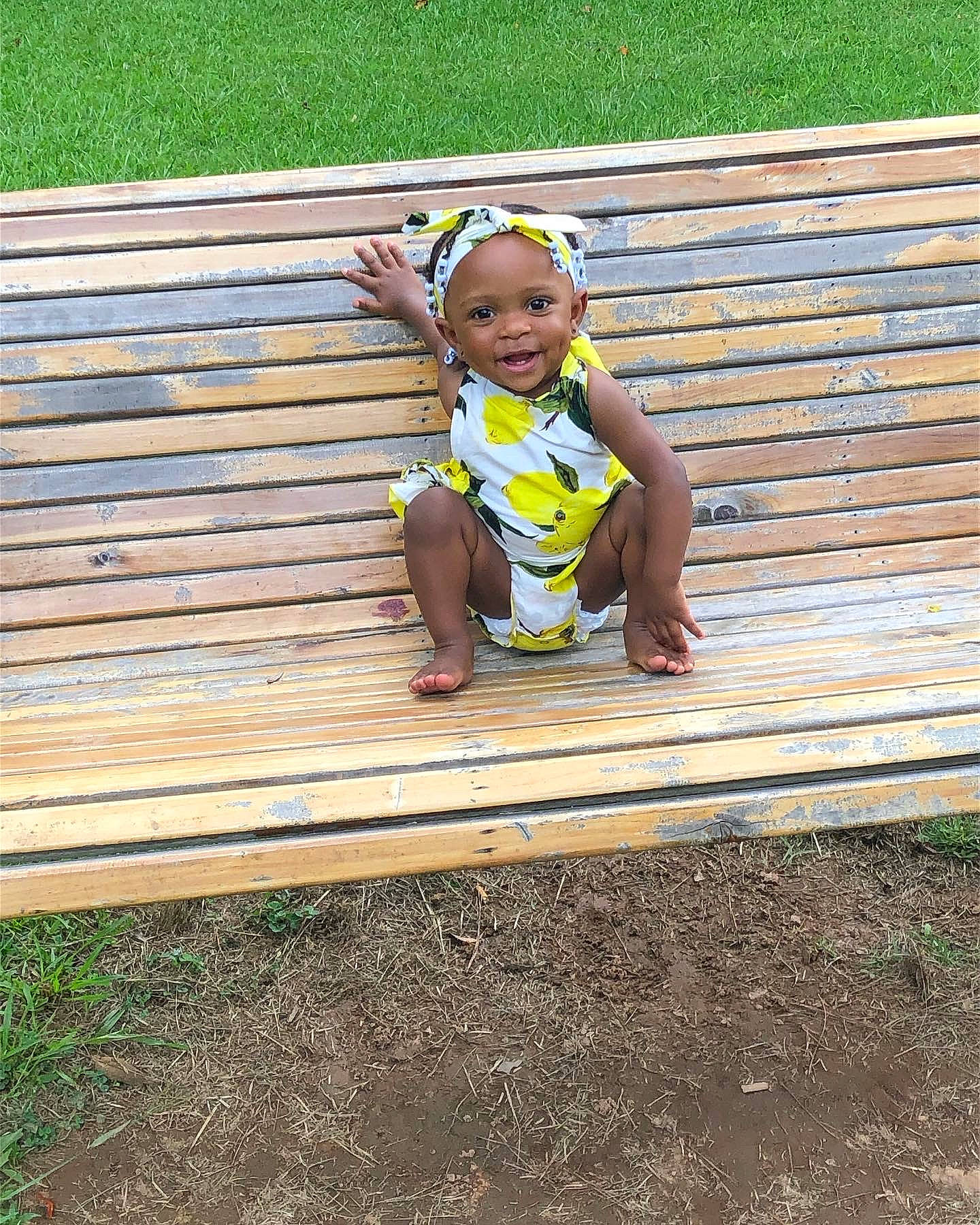 Janiyah joined the competition — help win amazing prizes! baby, baby_toddler_clothing, bench, child, grass, happy, hardwood, joy, leisure, outdoor_bench, outdoor_furniture, people_in_nature, person, plank, plant, sitting, smile, soil, t_shirt, toddler