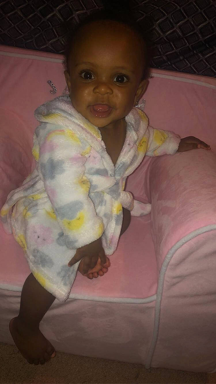 Janiyah is registered to the contest to win money with this photo: baby, baby_toddler_clothing, cheek, child, chin, comfort, eye, eyebrow, iris, linens, lip, mouth, nose, person, pink, purple, skin, sleeve, smile, textile