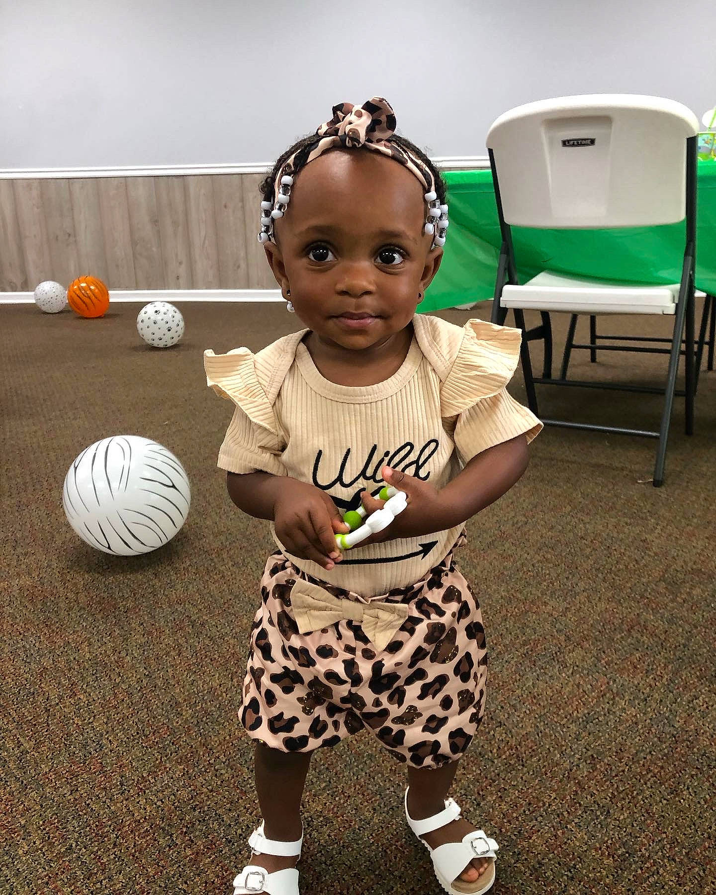 Janiyah joined the competition — help win amazing prizes! audio_equipment, baby, baby_toddler_clothing, ball, black, chair, child, floor, flooring, fun, green, happy, mammal, pattern, person, play, sitting, sleeve, t_shirt, toddler