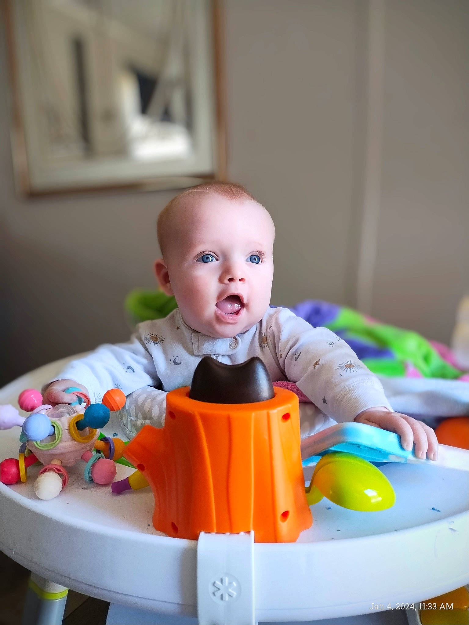 Freya is registered to the contest to win money with this photo: baby, baby_playing_with_toys, baby_products, baby_toddler_clothing, baby_toys, child, facial_expression, flooring, fun, happy, person, plastic, play, product, riding_toy, room, sitting, surprise, toddler, toy