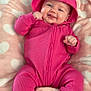 baby, child, infant, smiling, pink_onesie, hood, heart_blanket, cozy, chubby_cheeks, toes, hands, laying, portrait, cute, nursery, soft_texture, playful, fabric, infant_garment, happy