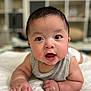 Drake is registered to the contest to win money with this photo: baby, infant, child, face, eyes, drool, hand, skin, arm, blanket, indoor, sleeveless_shirt, expression, cute, portrait, lying_down, closeup, soft_light, background_blur, furniture