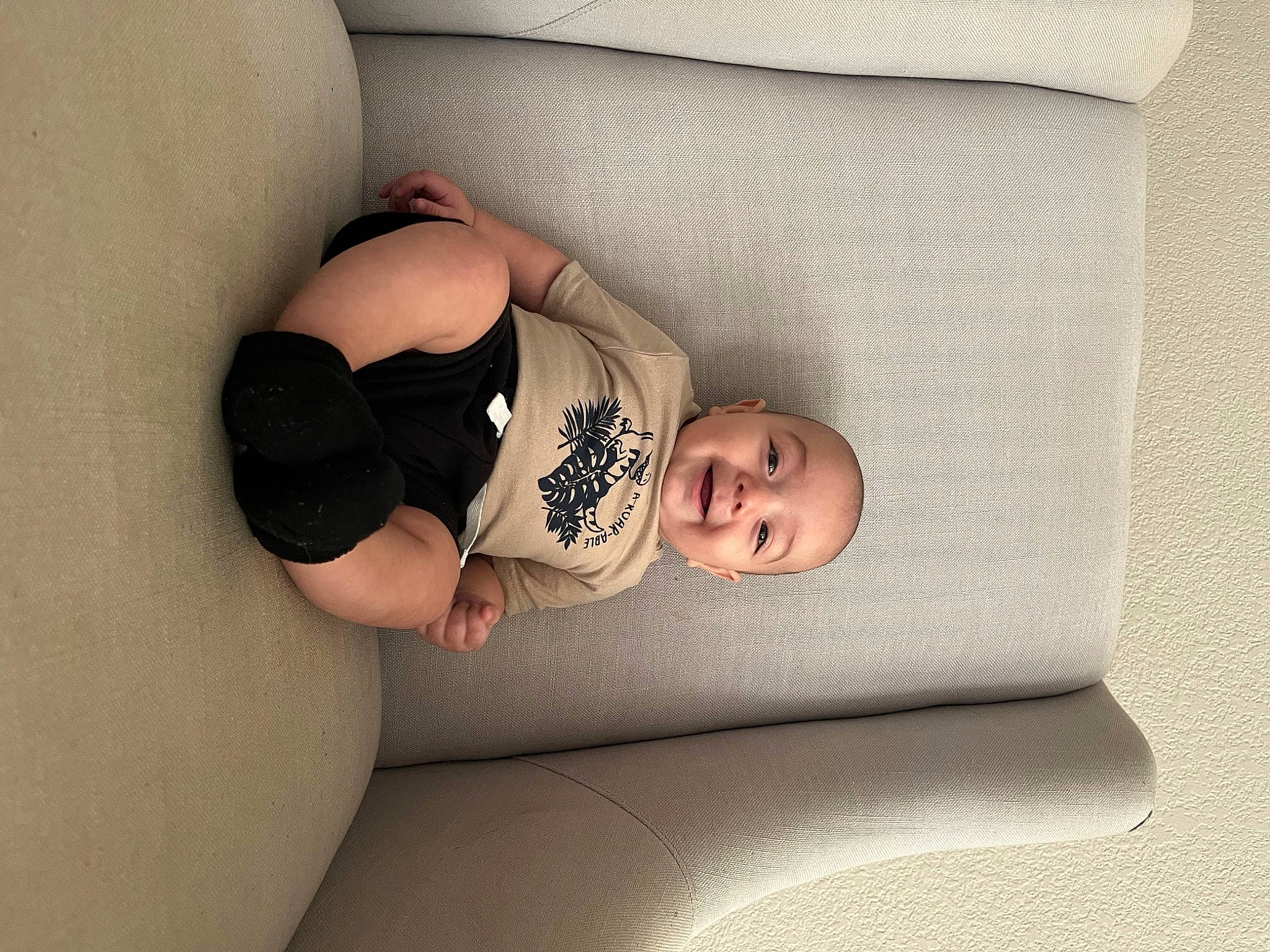 Arturo is registered to the contest to win money with this photo: baby, baby_sleeping, baby_toddler_clothing, child, comfort, couch, flooring, foot, headgear, human_body, human_leg, knee, leg, linens, person, room, sitting, textile, thigh, toddler