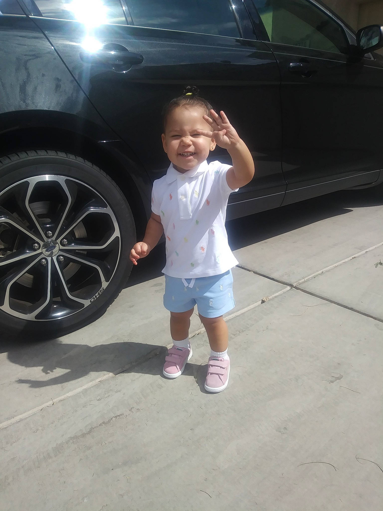 Destini is registered to the contest to win money with this photo: auto_part, automotive_tire, automotive_wheel_system, car, child, cool, day, family_car, fun, girl, mode_of_transport, person, rim, smile, standing, tire, vehicle, vehicle_door, wheel