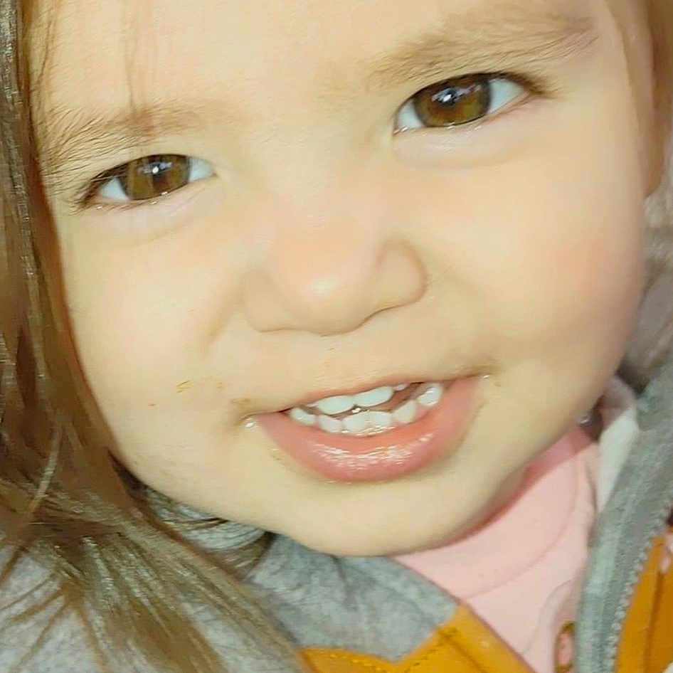Juliet is registered to the contest to win money with this photo: cheek, child, chin, ear, eye, eyebrow, eyelash, forehead, happy, iris, jaw, lip, mouth, neck, nose, outerwear, people, skin, smile, toddler