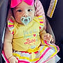 Helena is registered to the contest to win money with this photo: baby, child, pacifier, pink_bow, yellow_dress, striped_skirt, car_seat, infant, cute, adorable, sitting, clothing, footwear, bracelet, face, portrait, indoor, person, headwear, happy