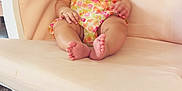 Helena joined the competition — help win amazing prizes! baby, child, smiling, pink_bow, floral_clothing, rocking_chair, beige_chair, indoor, carpet, baby_accessories, organizer, books, happy, cute, infant, portrait, sitting, comfortable, room, headband