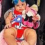 baby, child, car_seat, blue_bow, plush_toy, minnie_mouse, red_outfit, pink_blanket, barefoot, cute, infant, toy, chubby_legs, bracelet, headwear, indoors, person, sitting, clothing, accessory
